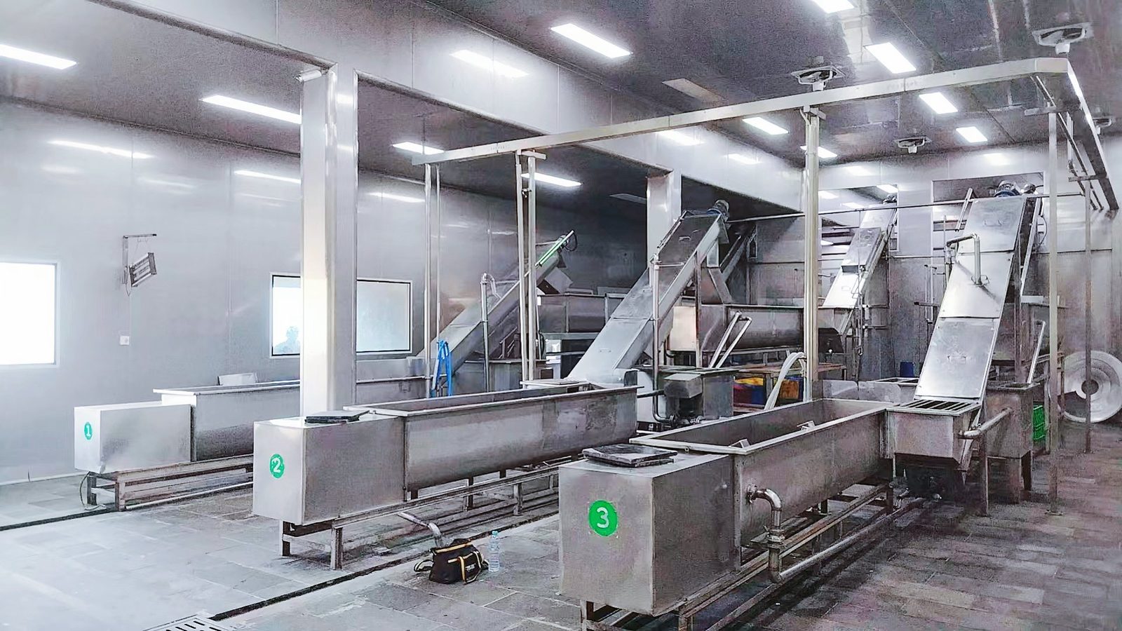 Factory washing and processing line with multi-stage conveyor system